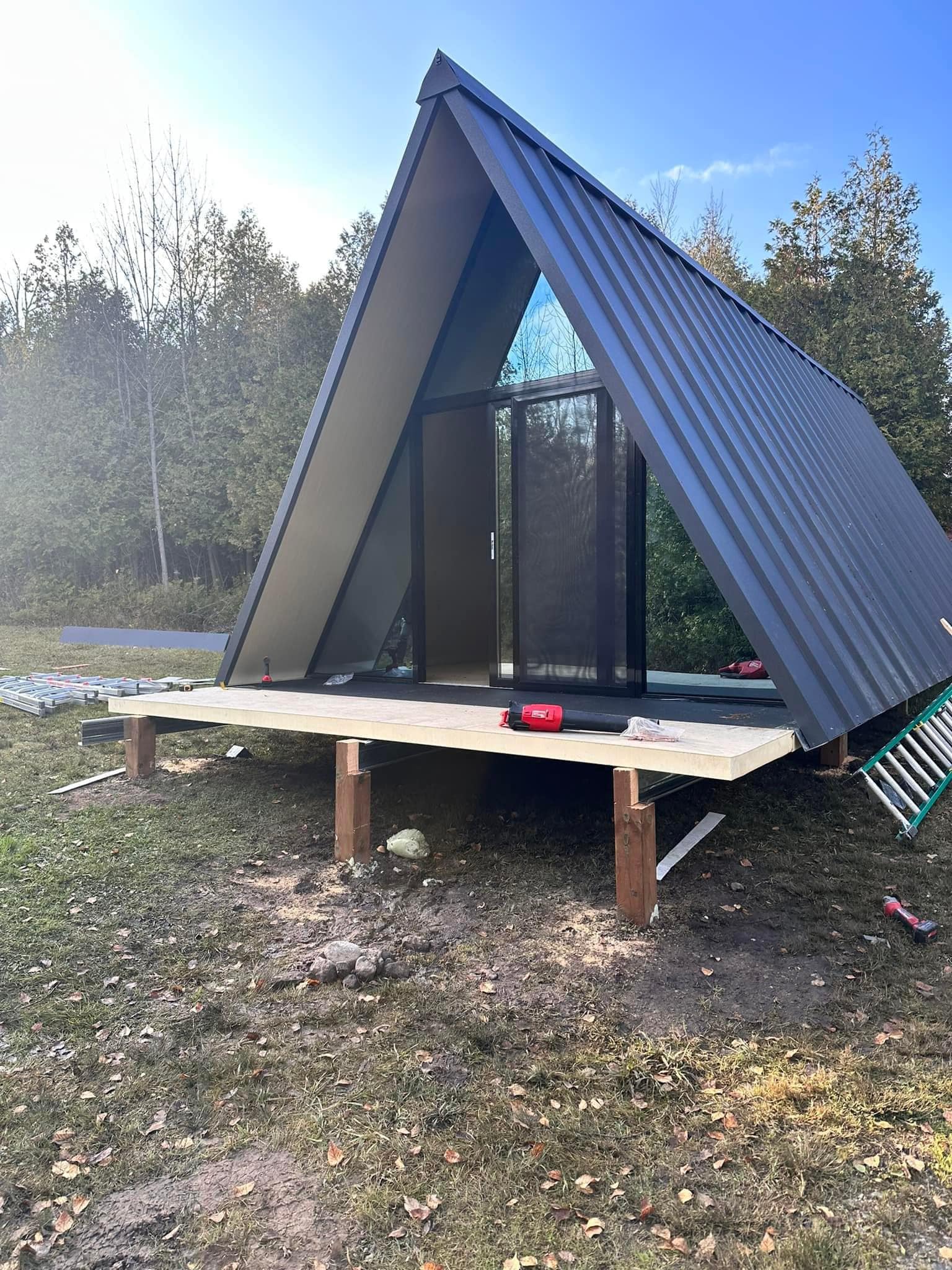 The meme is an image of a small, modern A-frame cabin with a large, empty space in front of it. The text "I can hear you" is written in a bold, red font in the empty space. The meme is likely referencing the idea that someone is trying to be quiet and not be heard, but the "I can hear you" text suggests that someone is still aware of their presence.